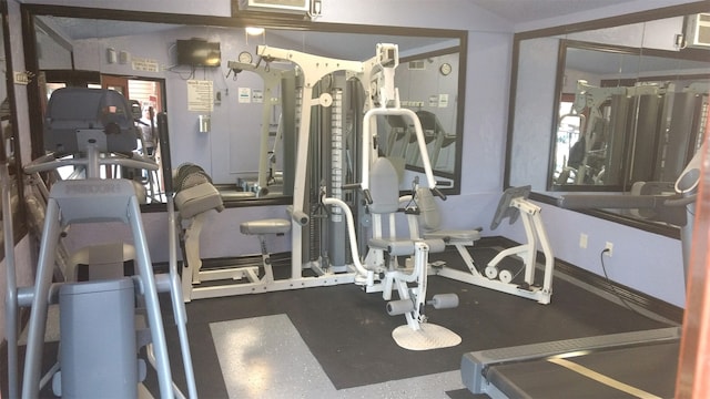 exercise room featuring vaulted ceiling