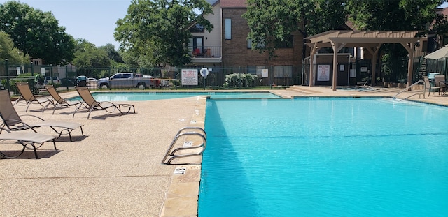 view of swimming pool with a patio area and a pergola