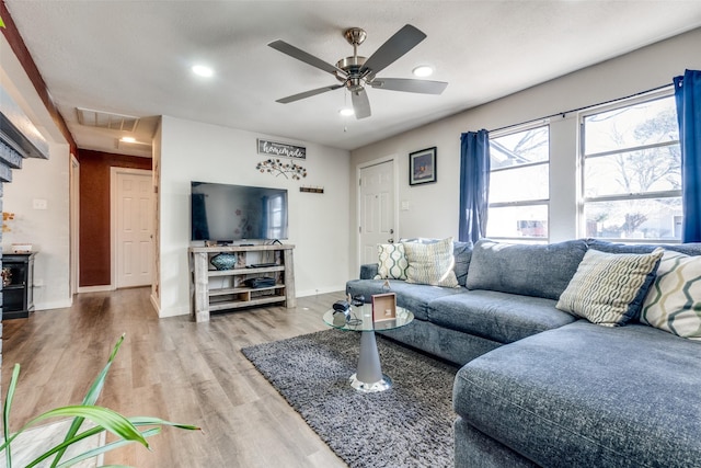 living room featuring hardwood / wood-style flooring and ceiling fan