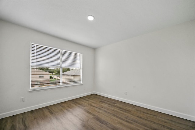 spare room featuring dark wood-type flooring