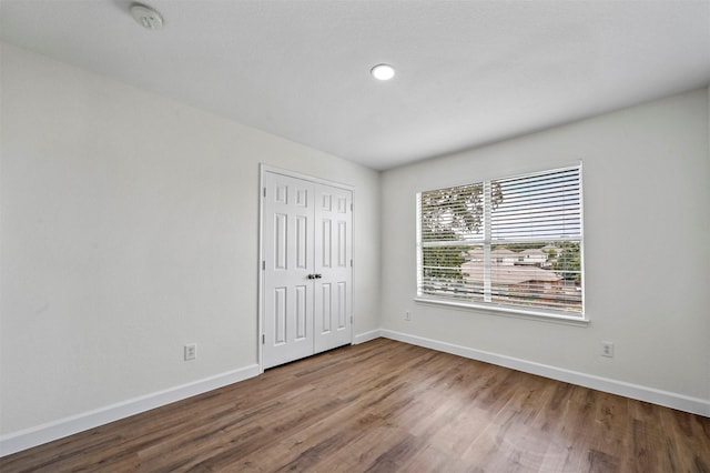 spare room with hardwood / wood-style flooring