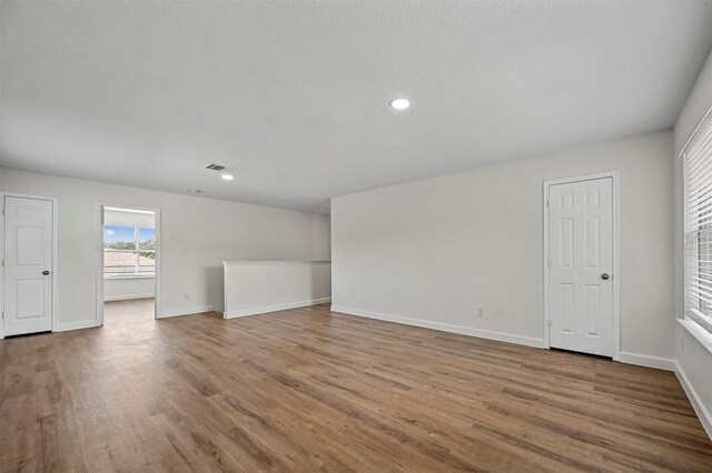 unfurnished room with light hardwood / wood-style flooring