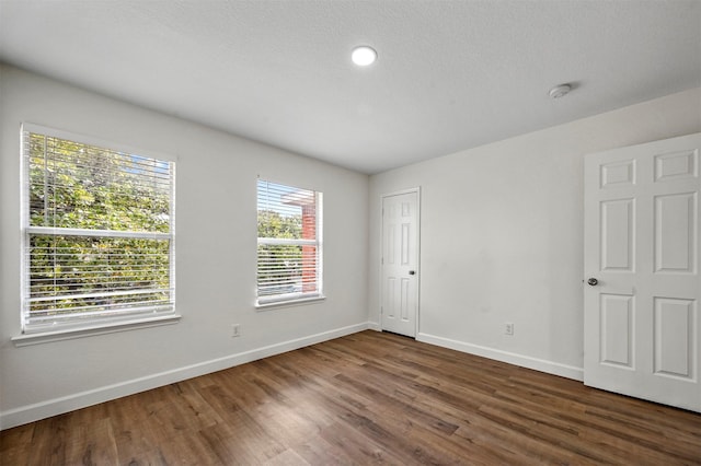 spare room featuring dark wood-type flooring