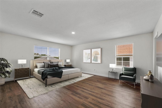 bedroom with dark hardwood / wood-style floors