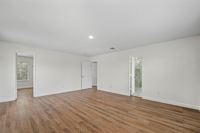 spare room with light hardwood / wood-style floors