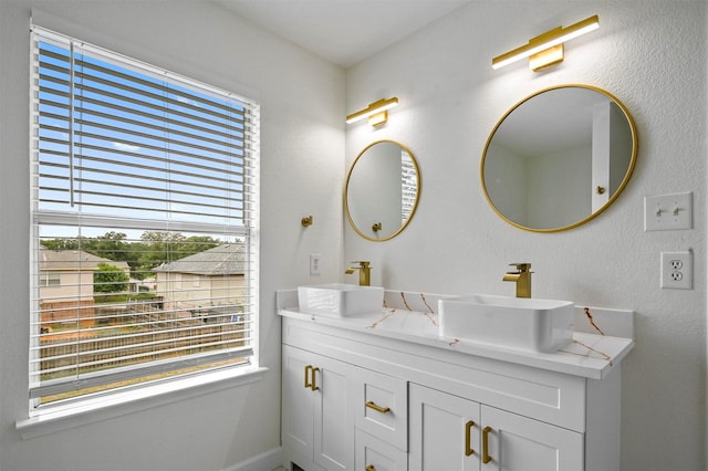 bathroom featuring plenty of natural light and vanity