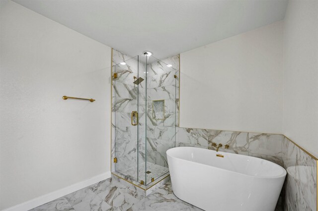 bathroom featuring separate shower and tub