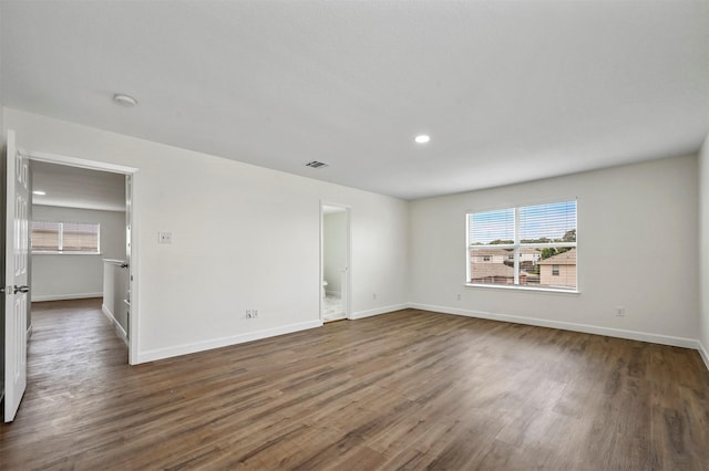 spare room with dark hardwood / wood-style floors