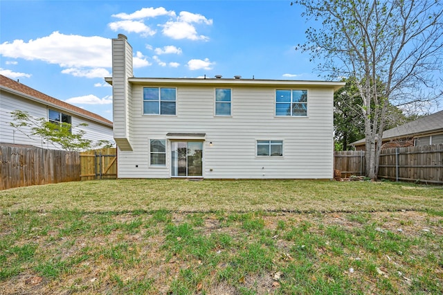 rear view of house with a lawn