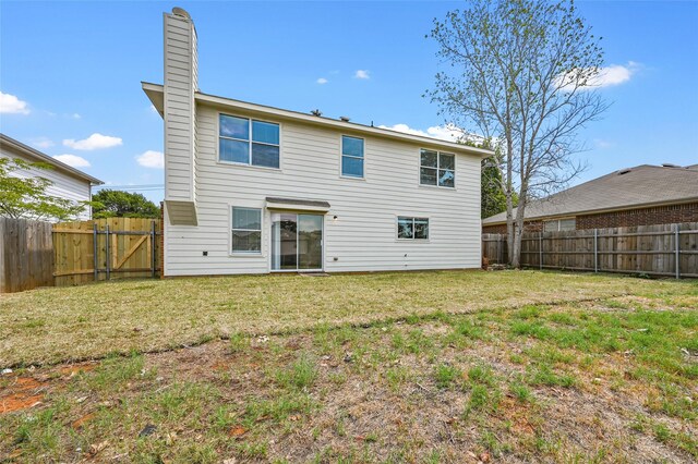 rear view of house with a yard