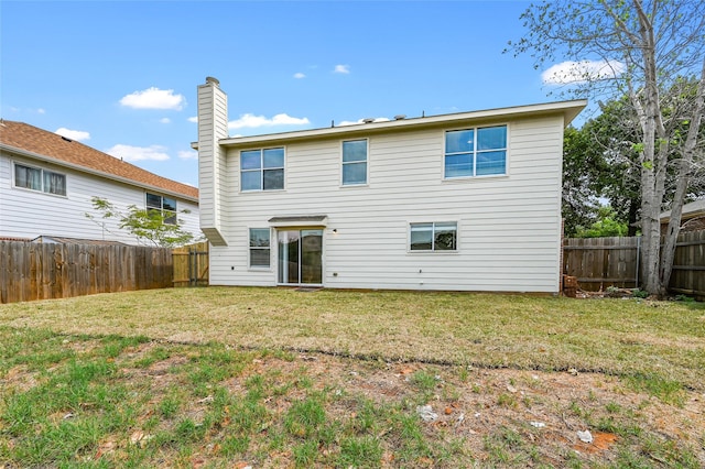 rear view of property with a yard