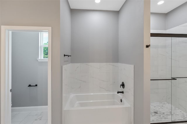 bathroom featuring shower with separate bathtub