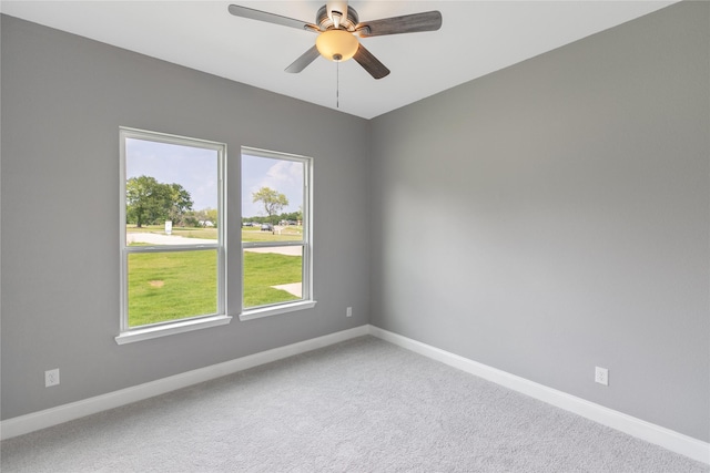 carpeted spare room with ceiling fan