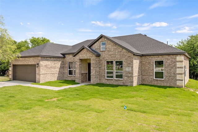 view of front facade with a garage and a front lawn