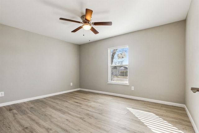 empty room featuring light wood-type flooring and ceiling fan