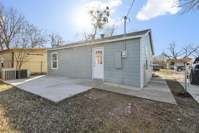 rear view of property featuring central air condition unit and a patio area