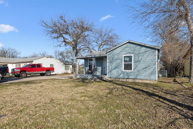 single story home featuring a front yard, a porch, and central AC