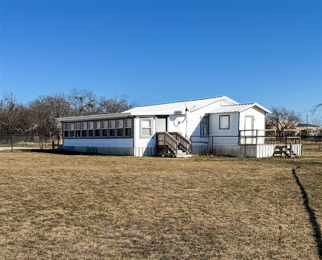 rear view of property with a lawn