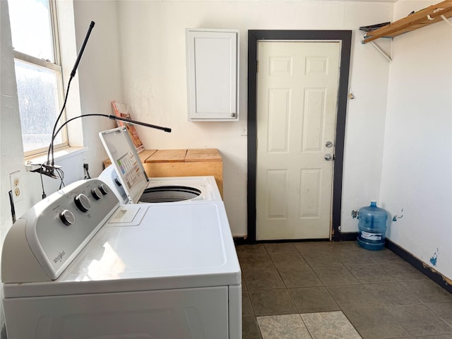 laundry area featuring washer and dryer and dark tile patterned floors