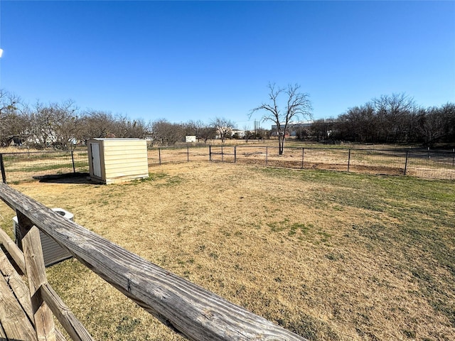 view of yard featuring a rural view and a storage shed