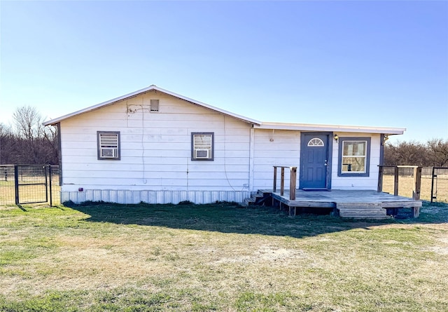 view of front of property with a wooden deck and a front yard