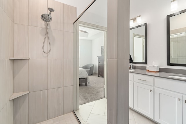 bathroom with vanity, tile patterned floors, and a shower