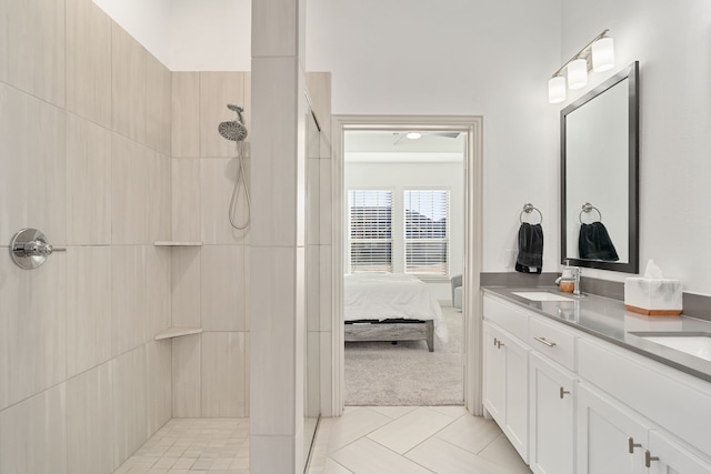 bathroom with vanity, tiled shower, and tile patterned floors