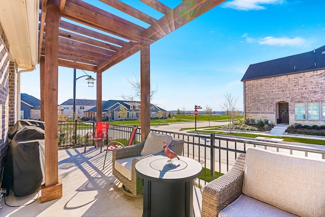 balcony featuring grilling area and a pergola