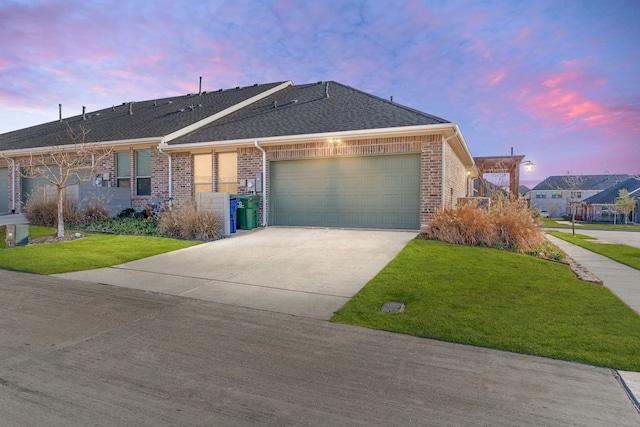 ranch-style house with a yard and a garage