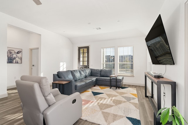 living room with lofted ceiling and light hardwood / wood-style floors