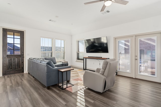 living room featuring ceiling fan and dark hardwood / wood-style floors