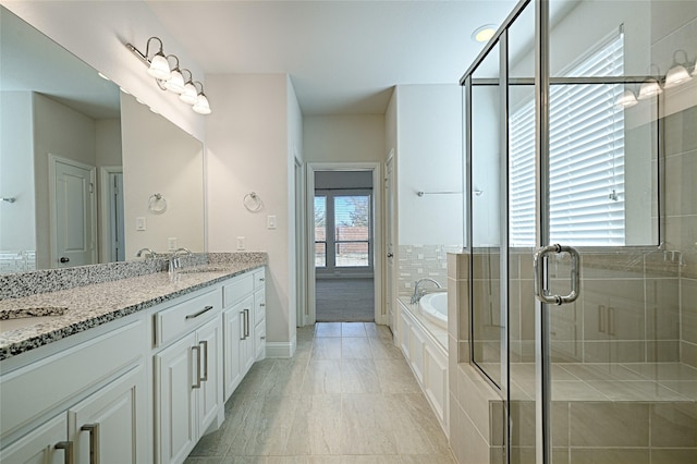 bathroom with vanity, tile patterned flooring, and plus walk in shower