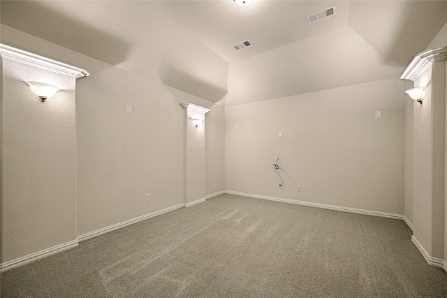 additional living space featuring vaulted ceiling and carpet flooring