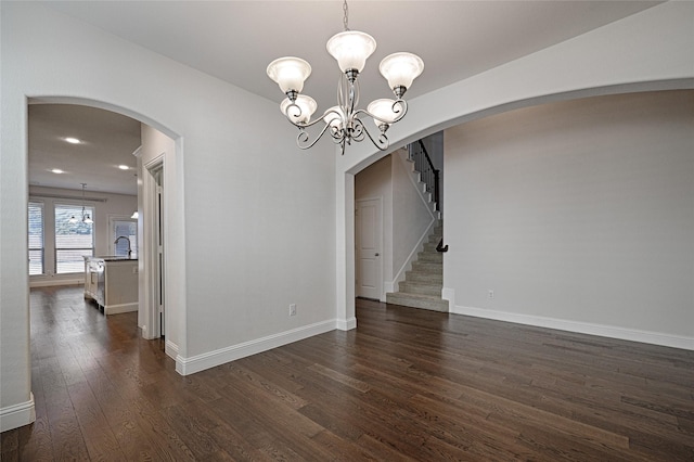 unfurnished dining area with dark hardwood / wood-style flooring, sink, and a chandelier