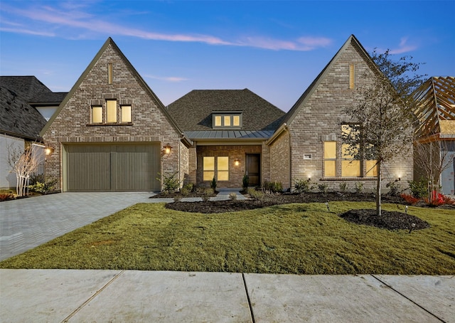 view of front of property with a yard and a garage