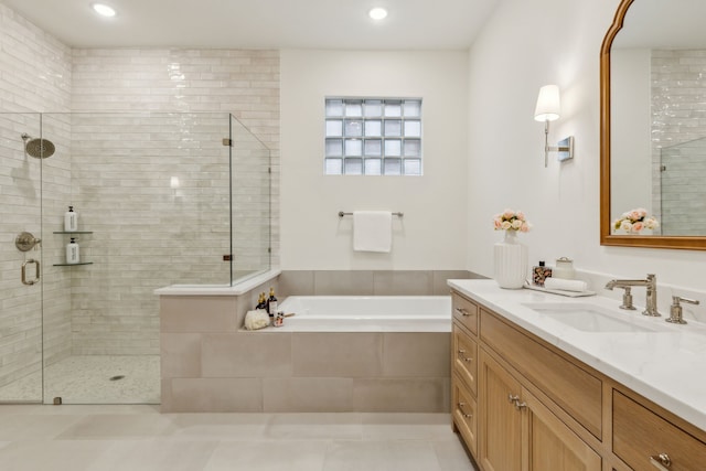 bathroom with tile patterned floors, vanity, and separate shower and tub