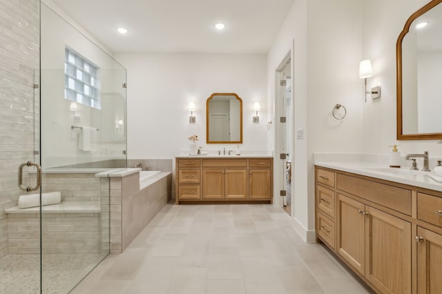 bathroom featuring independent shower and bath, vanity, and tile patterned flooring