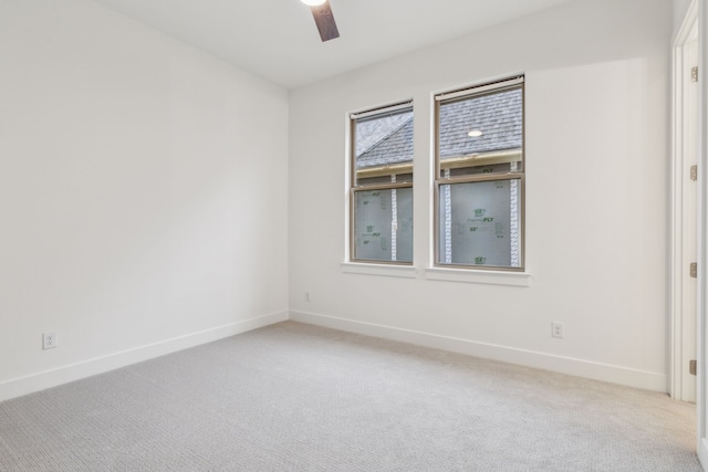 empty room with ceiling fan and light colored carpet