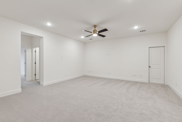 carpeted spare room with ceiling fan