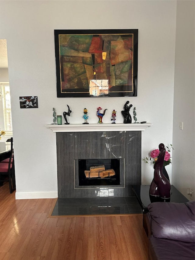 room details featuring hardwood / wood-style floors and a tile fireplace