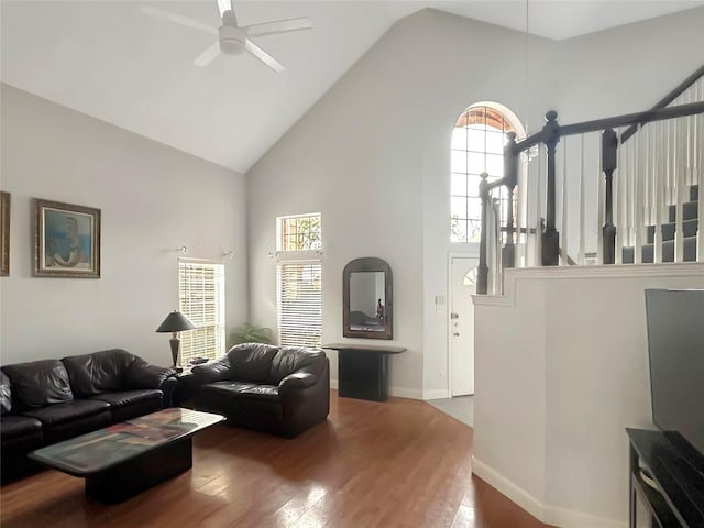 living room featuring ceiling fan, high vaulted ceiling, and hardwood / wood-style floors