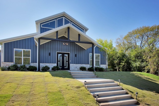 view of front of property with a front yard and french doors