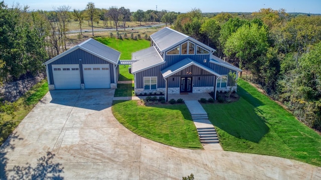 view of front facade featuring a front yard, an outbuilding, and a garage