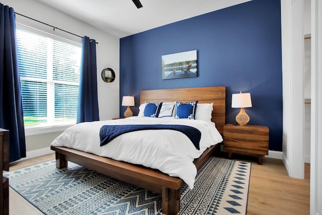 bedroom with ceiling fan and wood-type flooring