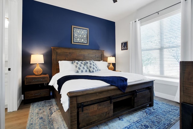 bedroom featuring light wood-type flooring and ceiling fan