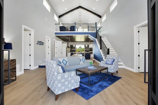 living room featuring a high ceiling and light hardwood / wood-style floors