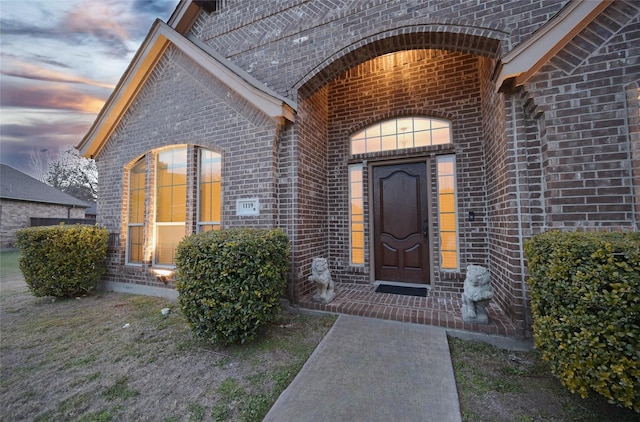 view of exterior entry at dusk