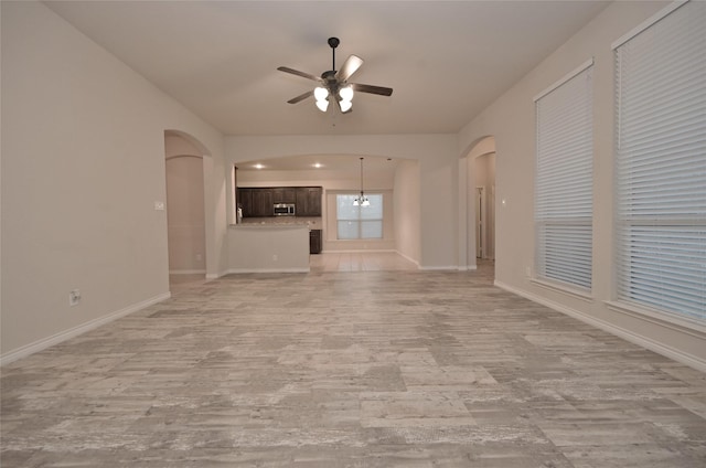 unfurnished living room featuring light wood-type flooring and ceiling fan