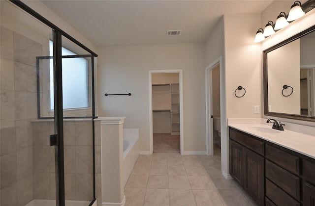 full bathroom with tile patterned floors, vanity, toilet, and shower with separate bathtub