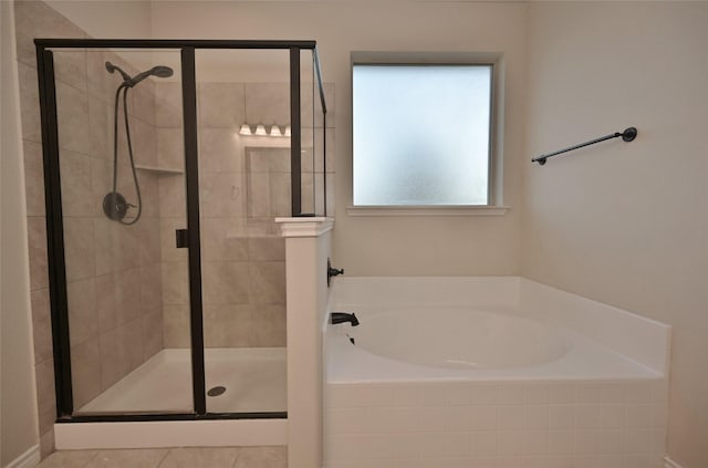 bathroom featuring shower with separate bathtub